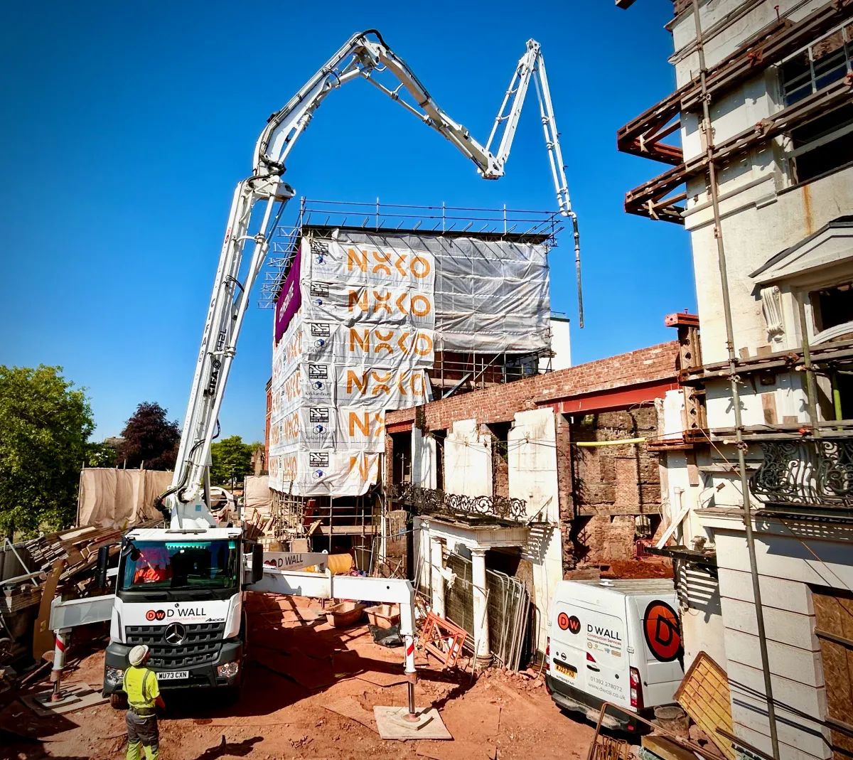 A concrete pump pouring the first new floor at the Royal Clarence